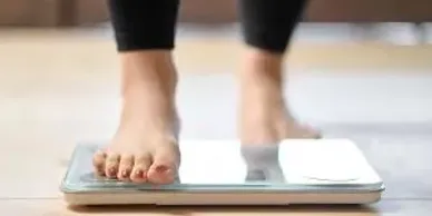 Stepping onto a scale as part of weight and wellness tracking