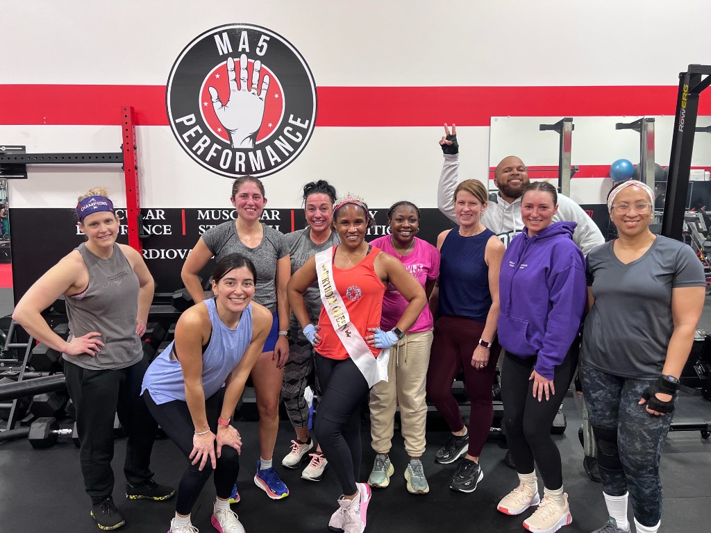 MA5 Performance members celebrating together at the gym